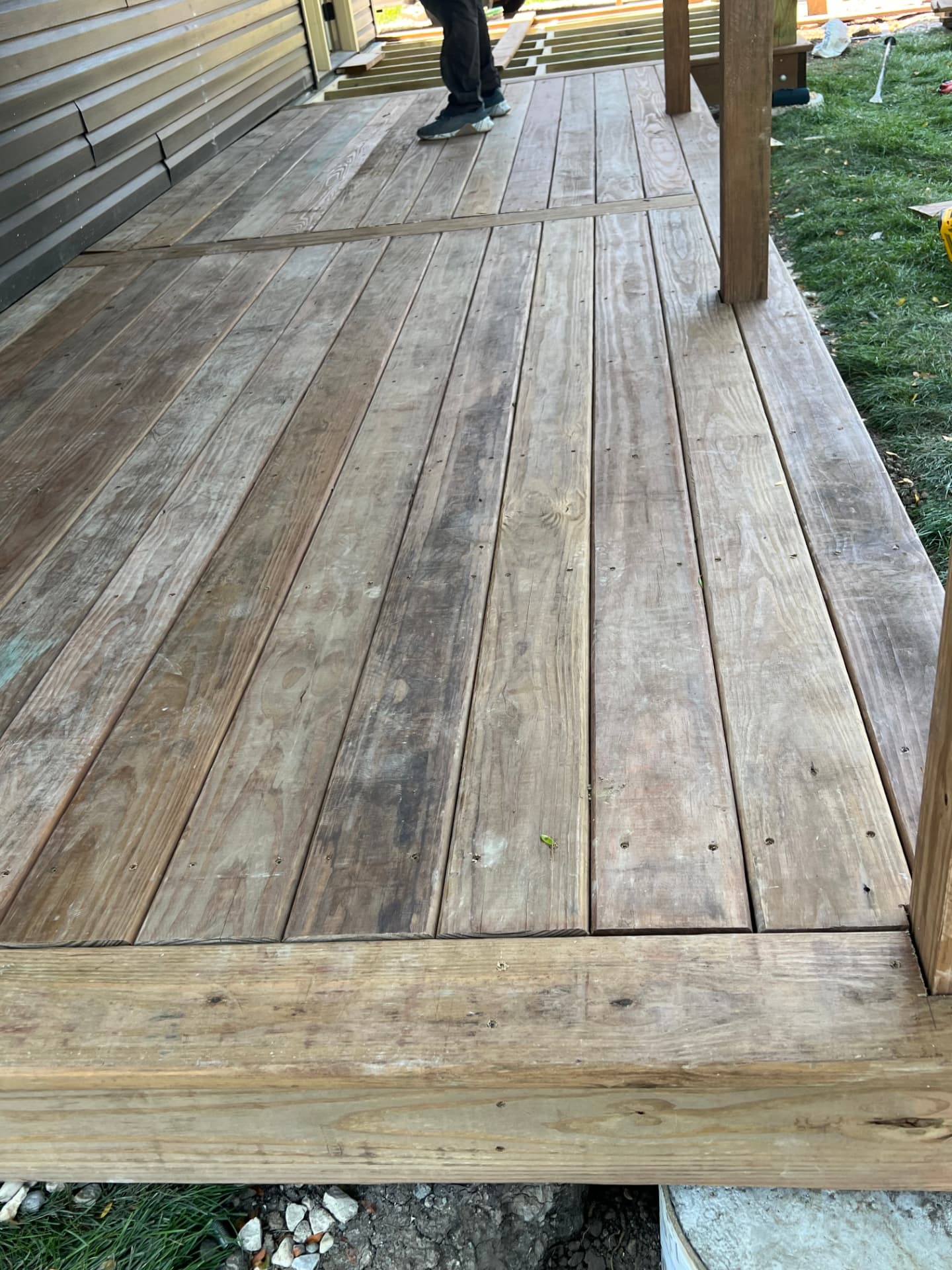 Newly built pressure-treated wood deck attached to a home